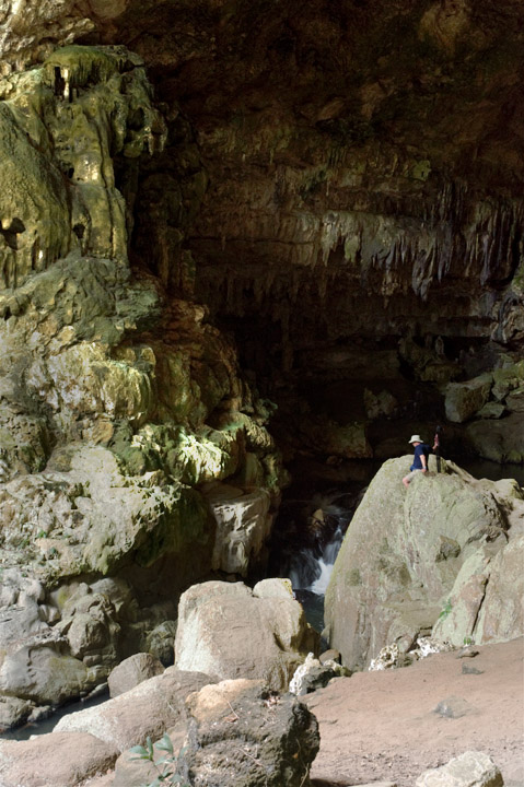 RioFrio_2107.jpg - Richard maneuvers down a boulder near the large cave entrance.